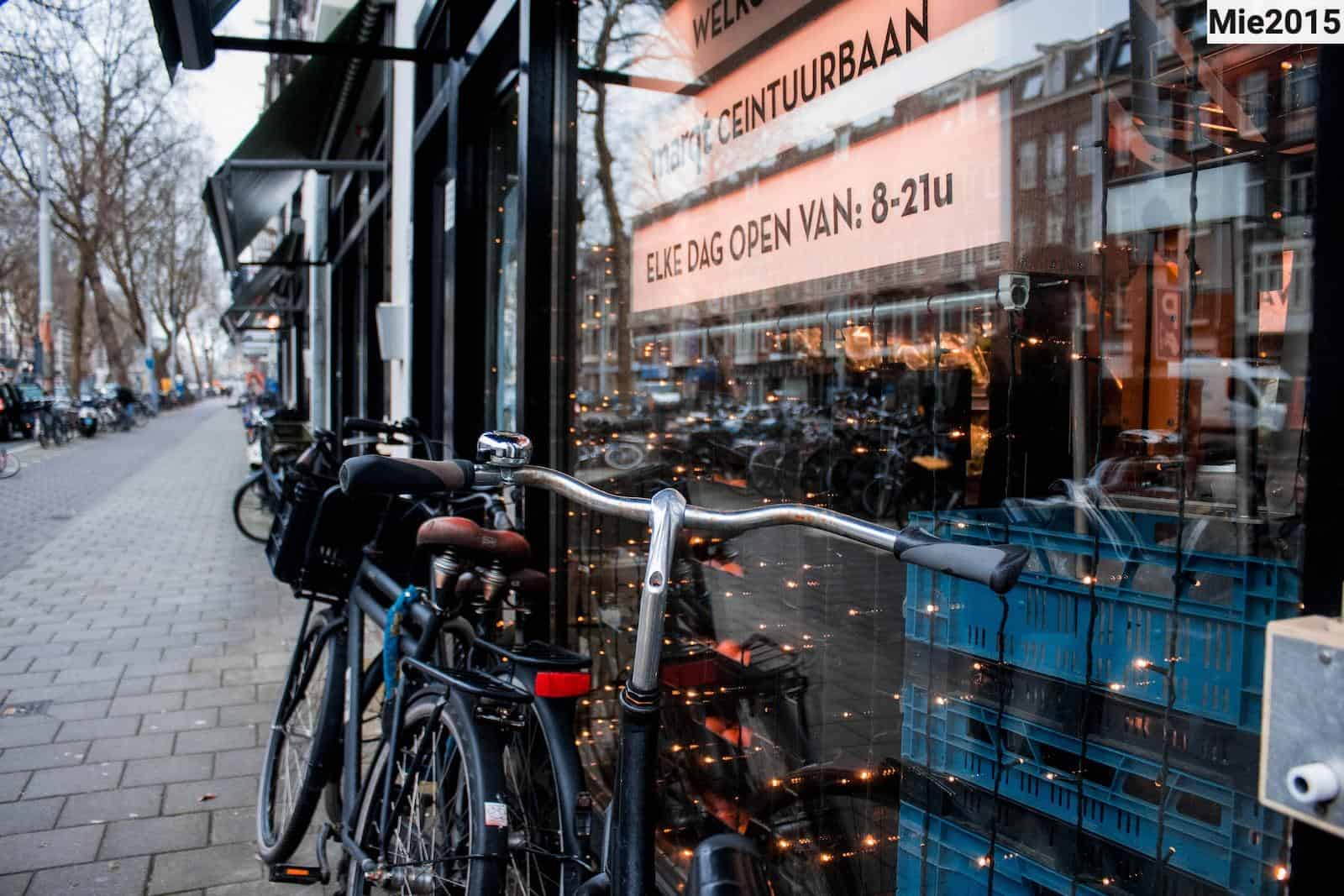 shallow focus photo of blue city bike parked on storefront